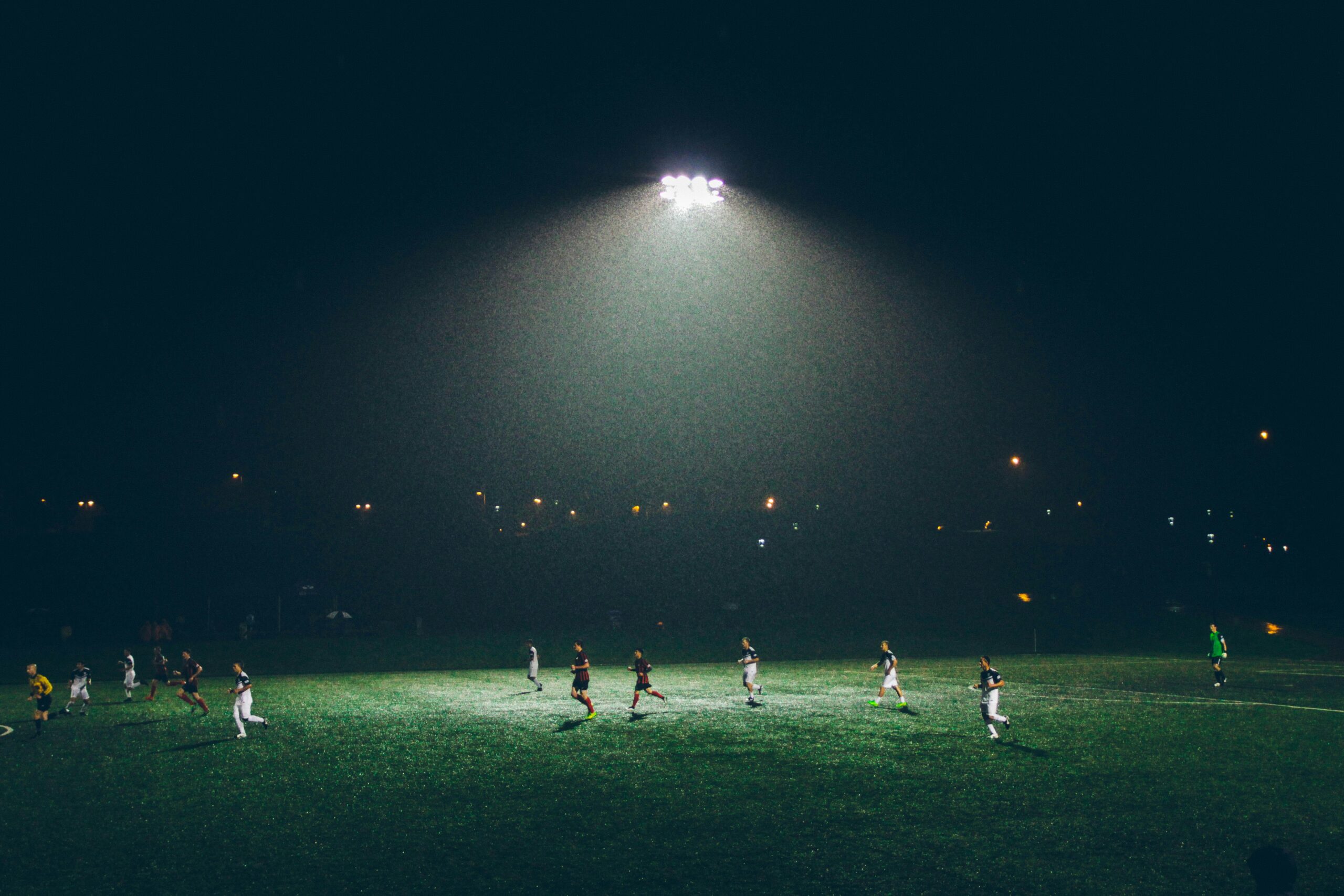 group of people playing soccer on soccer field